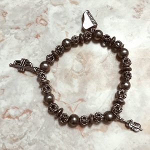 Silver bracelet with instrument charms